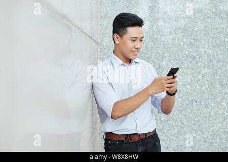 Smiling texting businessman Stock Photo