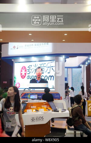 --FILE--People visit the stand of Aliyun, the cloud computing affiliate of Alibaba Group, at the Global Mobile Internet Conference 2013 (GMIC2013) in Stock Photo