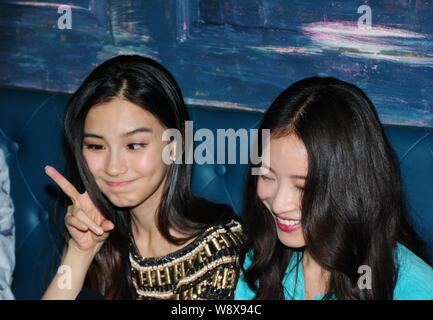 Hong Kong actress Angelababy, left, makes faces as Chinese actress Ni Ni smiles at a party to celebrate Ni¯s birthday and to mark the completion of th Stock Photo