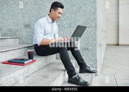 Software developer working on laptop Stock Photo