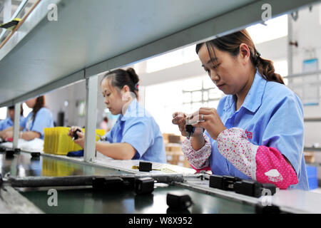 --FILE--Female Chinese workers produce circuit boards at an electronic products factory in Yichang city, central Chinas Hubei province, 4 September 20 Stock Photo