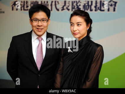 Kenneth Fok Kai-kong, eldest son of Hong Kong tycoon Timothy Fok Tsun-Ting, left, and his wife, Chinese Olympic diving champion Guo Jingjing, smile at Stock Photo