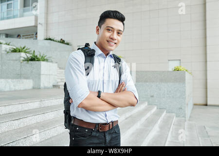Cheerful programmer standing outdoors Stock Photo