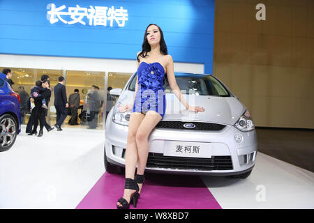 --FILE--A model poses with a Ford S-MAX during an auto show in Zhengzhou city, central Chinas Henan province, 6 November 2013.    Ford Motor Co on Tue Stock Photo