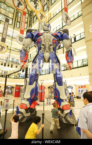 Visitors view a giant model of Optimus Prime from Hollywood movie, Transformers: Age of Extinction, during a promotional campaign for the Transformers Stock Photo