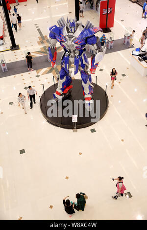Visitors view a giant model of Optimus Prime from Hollywood movie, Transformers: Age of Extinction, during a promotional campaign for the Transformers Stock Photo