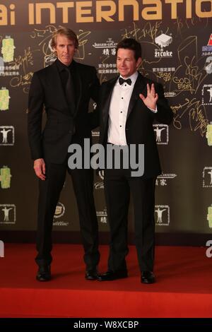 American director Michael Bay, left, and actor Mark Wahlberg from the cast of movie, Transformers: Age of Extinction, pose on the red carpet for the c Stock Photo