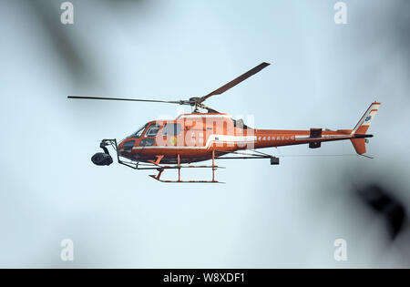 A helicopter flies to film scenes during a filming session for the movie, Transformers 4: Age of Extinction, at the Three Natural Bridges scenic spot Stock Photo