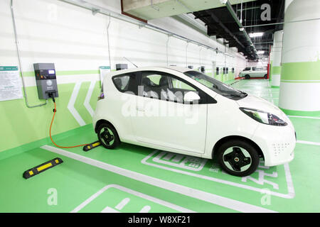 --FILE--An electric car is being charged at a charging station in Pudong, Shanghai, China, 5 June 2014.   China will exempt electric cars from purchas Stock Photo