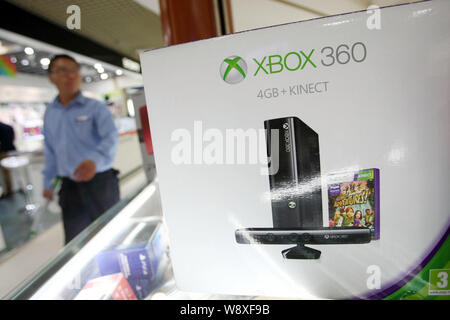 FILE--A young boy plays electronic games on an XBOX ONE game console at a  physical store of Microsoft in Shanghai, China, 26 December 2014. Produc  Stock Photo - Alamy