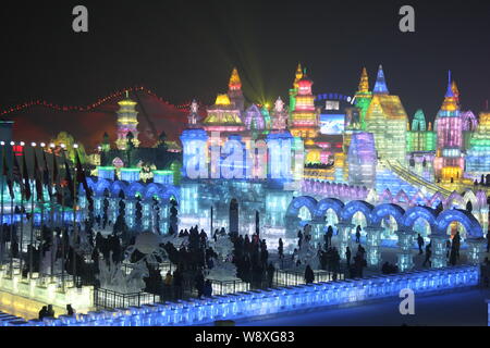 Visitors walk past ice sculptures at the 30th Harbin International Ice and Snow Festival in Harbin city, northeast Chinas Heilongjiang province, 5 Jan Stock Photo