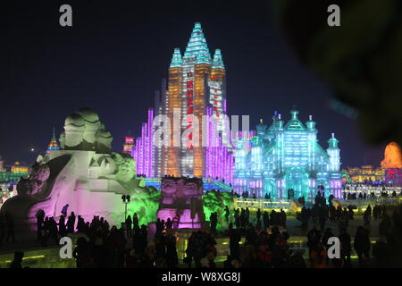 Visitors walk past ice sculptures at the 30th Harbin International Ice and Snow Festival in Harbin city, northeast Chinas Heilongjiang province, 5 Jan Stock Photo