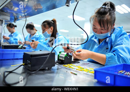 --FILE--Female Chinese workers produce electronic products on the ...