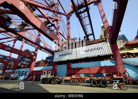 --FILE--Containers of Maersk are being lifted on a quay at the Port of Ningbo in Ningbo city, east Chinas Zhejiang province, 10 January 2014.   China Stock Photo