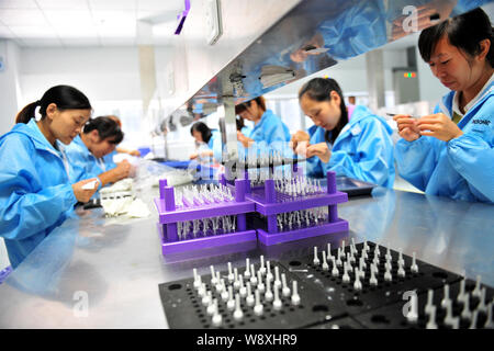--FILE--Female Chinese workers assemble a car on the assembly line at ...