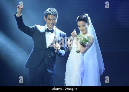 American actor Archie Kao, left, and Chinese actress Zhou Xun show their wedding rings during 'One Night' Charity Gala in Hangzhou City, China, 16 Jul Stock Photo