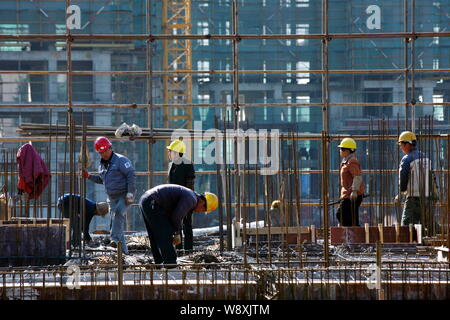 --FILE--Chinese migrant workers labor at the construction site of a government-funded residential project in Huaian city, east Chinas Jiangsu province Stock Photo