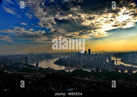 --FILE--Skyline of Yuzhong Peninsula with skyscrapers and high-rise buildings at the junction of the Yangtze River and the Jialing River at sunset in Stock Photo