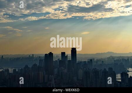 --FILE--Skyline of Yuzhong Peninsula with skyscrapers and high-rise buildings at the junction of the Yangtze River and the Jialing River at sunset in Stock Photo