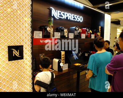 --FILE--Chinese customers shop at a Nespresso store in a shopping mall in Shanghai, China, 5 July 2014.   Chinas retail sales maintained steady growth Stock Photo