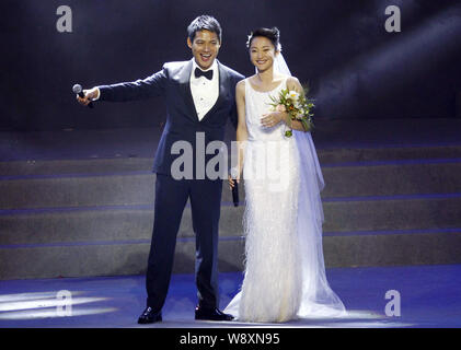 American actor Archie Kao, left, and Chinese actress Zhou Xun in a white wedding dress laugh after announcing their wedding during the One Night chari Stock Photo