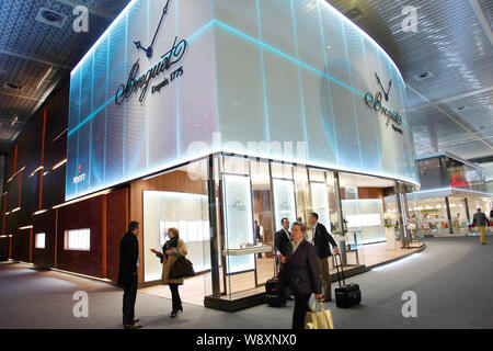 Visitors walk past the stand of Breguet during the Baselworld Watch