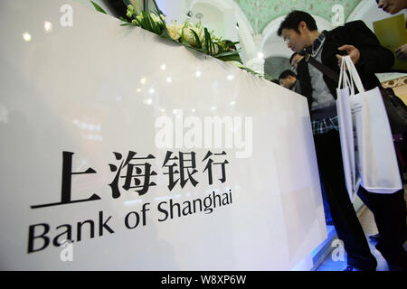 --FILE--People visit the stand of Bank of Shanghai during an exhibition in Shanghai, China, 25 November 2012.   The Bank of Shanghai is preparing to s Stock Photo