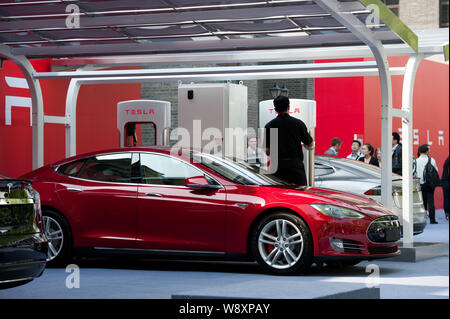 Tesla Model S electric cars to be delivered are parked at a charging station in Beijing, China, 22 April 2014.   Tesla Motors Inc. delivered its first Stock Photo