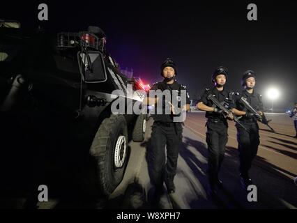 Special police officers armed with guns patrol a street in Beijing, China, 8 May 2014.   Beijing police patrol the northern part of the capital starti Stock Photo