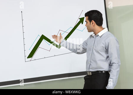 Businessman showing graph rising upward Stock Photo - Alamy