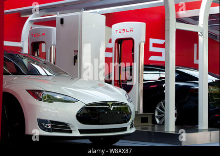 Tesla Model S electric cars to be delivered are parked at a charging station in Beijing, China, 22 April 2014.   Tesla Motors Inc. delivered its first Stock Photo