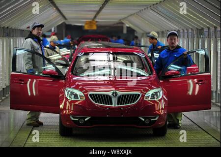 --FILE--Chinese workers assemble car on an assembly line at a plant of Brilliance Auto Group in Shenyang city, northeast Chinas Liaoning province, 21 Stock Photo