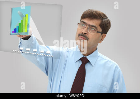 Businessman analyzing financial data on advanced touch screen monitor Stock Photo