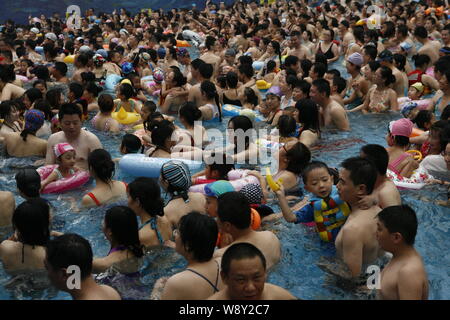 --FILE--Holidaymakers crowd a swimming pool to cool down in an indoor water park at the National Aquatics Center, also known as the Water Cube, in Bei Stock Photo