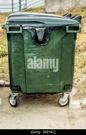 Dumpster in park. One garbage outdoor. View side Stock Photo