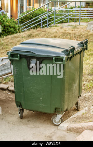 Dumpster in park. One garbage outdoor. Stock Photo