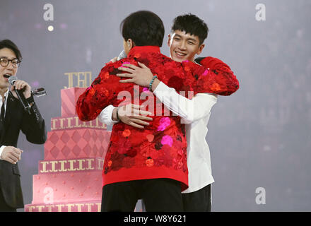 --FILE--Taiwanese actor Kai Ko (R) hugs Jaycee Chan's father Jackie Chan during latter's 60th birthday charity concert in Beijing, China, 6 April 2014 Stock Photo