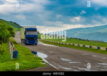 Wagon on the roads of Armenia on a cloudy day with textural dark clouds Stock Photo