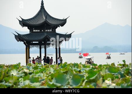Tourists visit the West Lake in Hangzhou city, east Chinas Zhejiang province, 26 September 2013. Stock Photo
