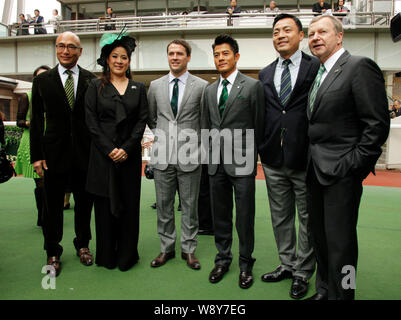 English football star Michael Owen, third left, Hong Kong singer and actor Aaron Kwok, third right, pose with other guests at the Kent & Curwen Centen Stock Photo