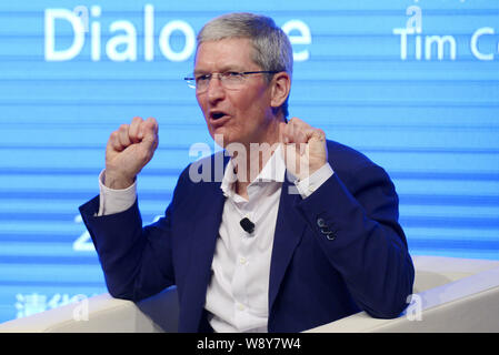 Tim Cook, CEO of Apple Inc., speaks at a dialogue with Qian Ying, dean of the School of Economics and Management (SEM), during the Tsinghua Management Stock Photo