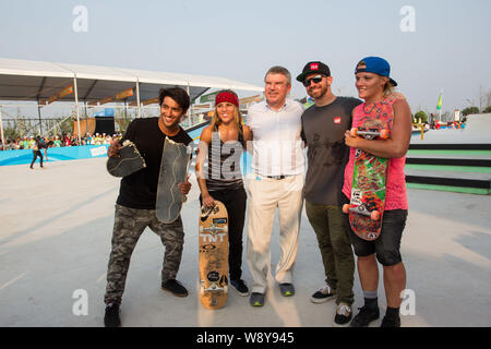 Thomas Bach, center, president of the International Olympic Committee (IOC), poses with skateboard players as he visits the Nanjing 2014 Sports Lab du Stock Photo