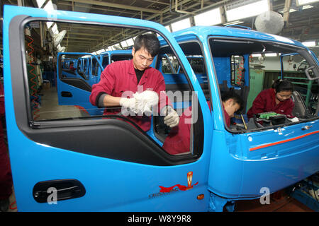 --FILE--Chinese workers assemble trucks on the assembly line at the ...