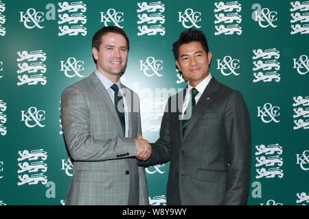 English football star Michael Owen, left, shakes hands with Hong Kong singer and actor Aaron Kwok at the Kent & Curwen Centenary Sprint Cup horse race Stock Photo