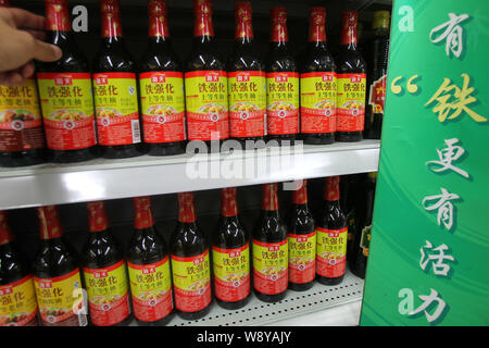 --FILE--A customer buys a bottle of Haitian superior light soy sauce of Foshan Haitian Flavouring and Food Co. at a supermarket in Nantong, east China Stock Photo