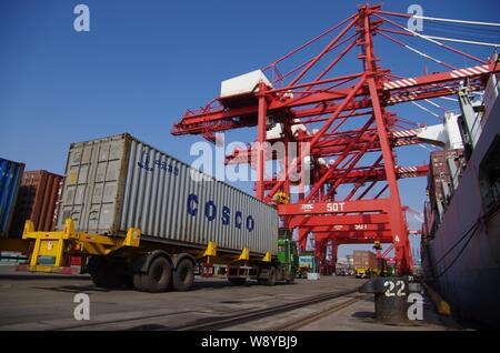--FILE--A truck transports a container of COSCO (China Ocean Shipping (Group) Co.) at the Port of Rizhao in Rizhao city, east Chinas Shandong province Stock Photo