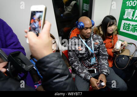 Former NBA star Stephon Marbury of Beijing Ducks Basketball Club, center, takes a subway train of the Beijing Metro Line 1 in Beijing, China, 8 Decemb Stock Photo