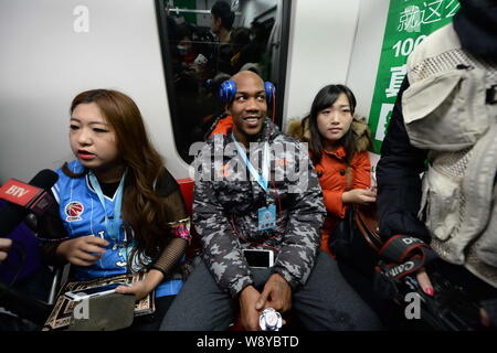 Former NBA star Stephon Marbury of Beijing Ducks Basketball Club, center, takes a subway train of the Beijing Metro Line 1 in Beijing, China, 8 Decemb Stock Photo