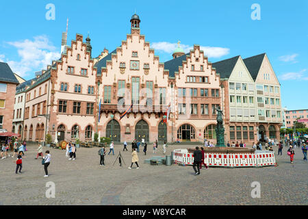 FRANKFURT, GERMANY - JUNE 13, 2019: tourists in Romerberg square with the city hall and justice statue on blue sky, main landmark of Frankfurt, German Stock Photo