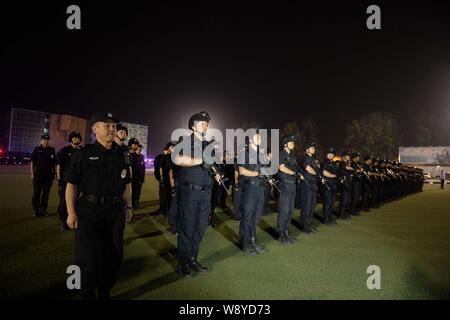 Special police officers armed with guns gather at the base camp of Beijings Special Police Force Corp. before a city patrol in Beijing, China, 8 May 2 Stock Photo